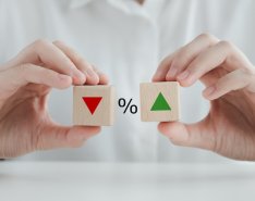 Percentage symbol between down arrow and up arrow to indicate interest rates holding 