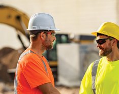 Two smiling construction workers to demonstrate a caring culture