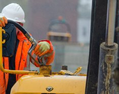 Construction worker using gas pump