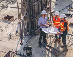 Three contractors looking at a plan