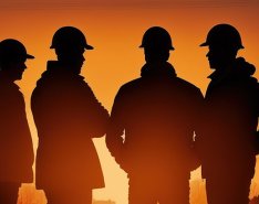 silhouette of five construction workers in hardhats during sunset