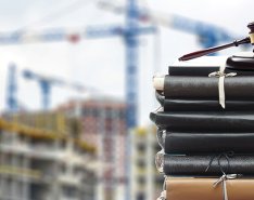 gavel in front of jobsite to illustrate construction law 