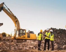 Construction workers on jobsite with equipment