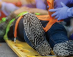 Injured construction worker surrounded by medical professionals 