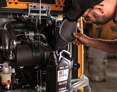 Man wearing CASE shirt and working on equipment