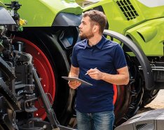 Man taking notes in front of construction fleet