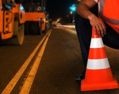 construction worker by traffic cone