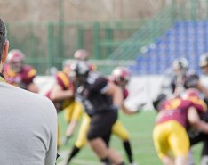 Football coach watching players