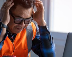 Man holding head as if frustrated