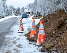 Snowy road with orange traffic cones