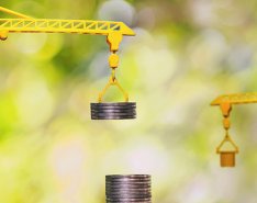 Toy cranes lifting and stacking coins