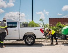Two construction workers handling equipment from Sunbelt Rentals 