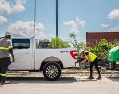 Two construction workers handling equipment from Sunbelt Rentals 