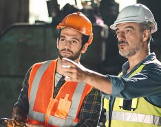 Two male construction workers looking off-camera