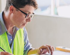 Man in vest working at desk