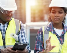 two construction workers talking