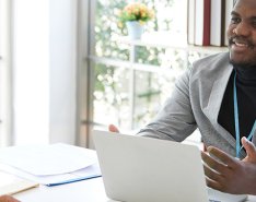 Two workers meeting across an office desk