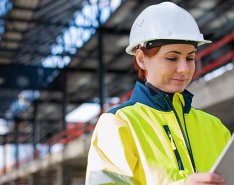 female construction worker looking at tablet 