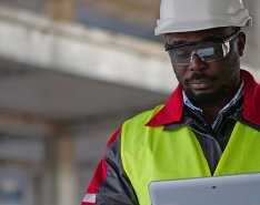 Construction worker looking at tablet