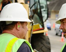 two construction workers talking
