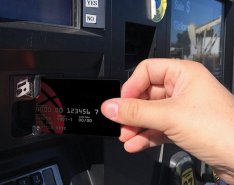 Person Putting Credit Card in ATM