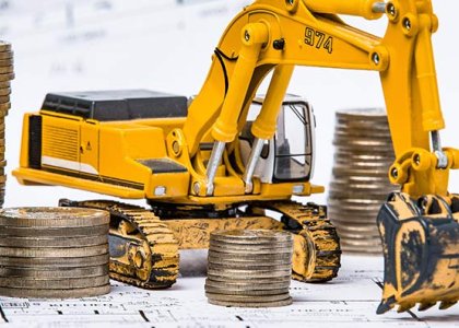 Toy excavator by rows of coins to represent construction financial options