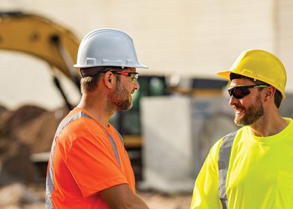 Two smiling construction workers to demonstrate a caring culture