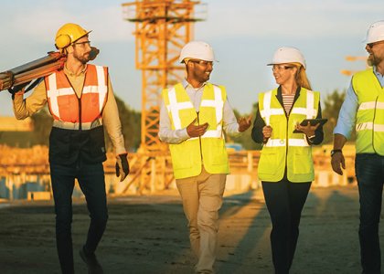 Construction workers happily talking/Adobe Stock 