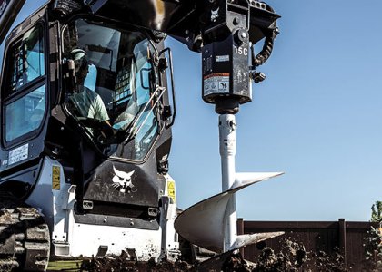 Bobcat T66 compact track loader with auger attachment 