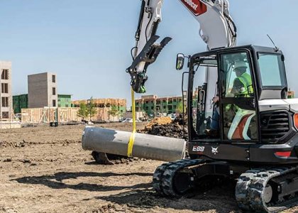 Bobcat excavator moving material on jobsite