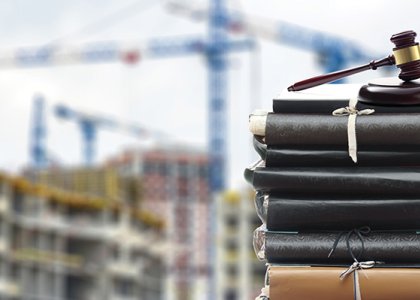 gavel in front of jobsite to illustrate construction law 