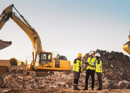 Construction workers on jobsite with equipment