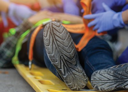 Injured construction worker surrounded by medical professionals 