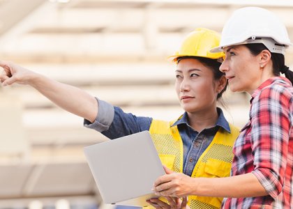 Two women in hard hats/Adobe Stock