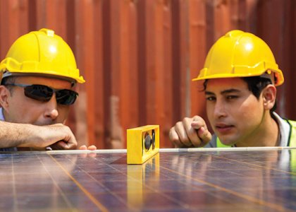 Two construction workers working together