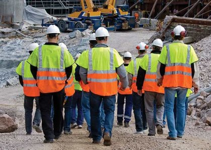 A group of construction workers walking to a jobsite to illustrate a strong workforce 
