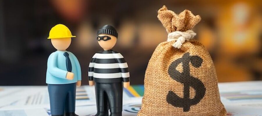 figurine construction worker and robber talking beside a money bag