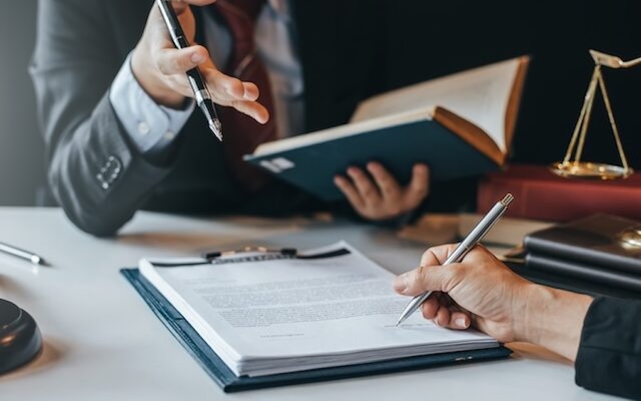 Lawyers reviewing and signing legal documents
