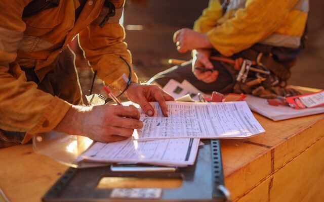 construction worker signing documents