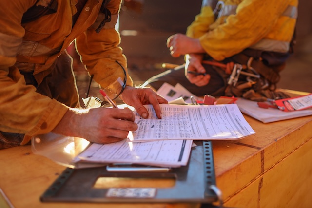 construction worker signing documents