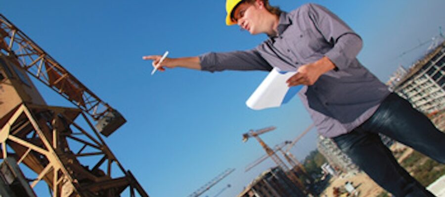 Construction manager reviewing plans at jobsite