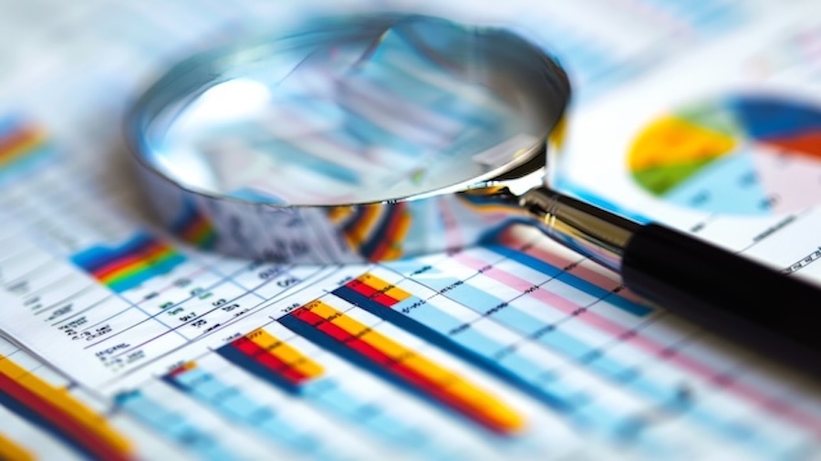 magnifying glass over financial report