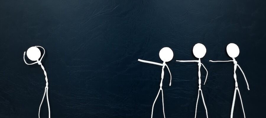 four stick figures pointing fingers at one