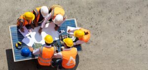 construction workers reviewing plans onsite