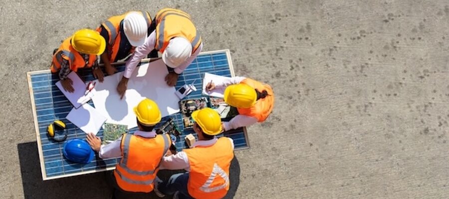 construction workers reviewing plans onsite