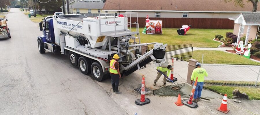 construction workers pouring volumetric concrete