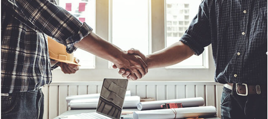 men shaking hands after signing a contract