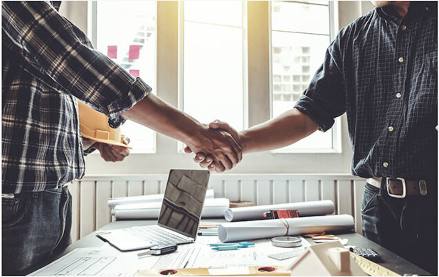 men shaking hands after signing a contract