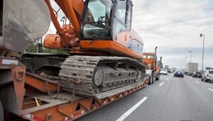 Excavator transported on lowboy trailer