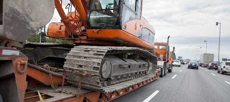 Excavator transported on lowboy trailer